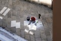 A stonemason at work in a stone paving street in the historic centre of Santiago de Compostela in Spain. Royalty Free Stock Photo