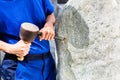 Stonemason working on boulder with sledgehammer and iron Royalty Free Stock Photo