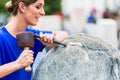 Stonemason working on boulder with sledgehammer and iron Royalty Free Stock Photo