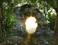 Stonepath through a rock arch in a magical lush forest flanked by ivy covered trees Royalty Free Stock Photo