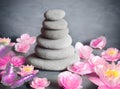 Stones balance with flower lily and butterfly on grey background Royalty Free Stock Photo