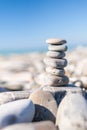 Stones balance, pebbles stack over blue sea . Blue sky on sunny adriatic coast in summer Royalty Free Stock Photo