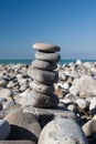 Stones balance, pebbles stack over blue sea Royalty Free Stock Photo