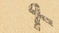 Stones on beach sand handmade symbol shape, golden sandy background, breast cancer symbol Royalty Free Stock Photo