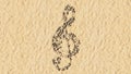 Stones on beach sand handmade symbol shape, golden sandy background, musical note sign Royalty Free Stock Photo