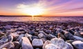 Stones on a beach with sunset on the ocean sea. Royalty Free Stock Photo