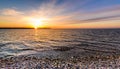 Stones on a beach with sunset on the ocean sea. Royalty Free Stock Photo