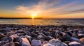 Stones on a beach with sunset on the ocean sea. Royalty Free Stock Photo