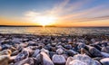 Stones on a beach with sunset on the ocean sea. Royalty Free Stock Photo