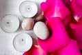 Stones, candles and pink rose petals on a white shabby chic tray. Spa welness concept Royalty Free Stock Photo