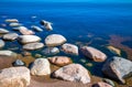 Stones in clear blue lake water. Lake Ladoga, Russia