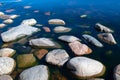Stones in clear blue lake water. Lake Ladoga, Russia