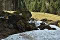 Stones covered with moss and snow on the alps meadow from tourist path towards to Murg lakes Royalty Free Stock Photo