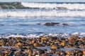 Stones Covering South Carlsbad State Beach with Crashing Waves Royalty Free Stock Photo