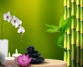 Stones, flowers, wax and bamboo on the table Royalty Free Stock Photo