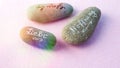 Stones with german words for Love, Believe and Hope on pink back Royalty Free Stock Photo