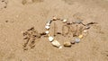Stones in heart shape laid out by hand on sand of sesa beach Royalty Free Stock Photo