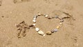 Stones in heart shape laid out by hand on sand of sesa beach Royalty Free Stock Photo