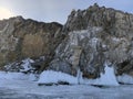 Stones and ice blocks covered with snow near the frozen Lake Baikal Royalty Free Stock Photo