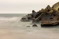 Stones laid on a breakwater in a sea port. The exhibition photographed with a long time Royalty Free Stock Photo