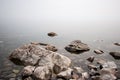 Stones on the lake in the fog.