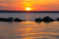 Stones in lake water on nice sunset sky background Royalty Free Stock Photo