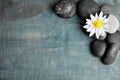 Stones with lotus flower and space for text on wooden background, flat lay. Zen lifestyle Royalty Free Stock Photo