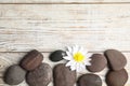 Stones with lotus flower and space for text on wooden background, flat lay. Zen lifestyle Royalty Free Stock Photo