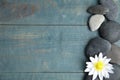 Stones with lotus flower and space for text on wooden background, flat lay. Zen lifestyle Royalty Free Stock Photo