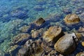 Colored pebbles under water at the coast of Mediterranean sea. Royalty Free Stock Photo