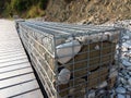 Stones in metal wire cage - Steel mesh of gabion wall Royalty Free Stock Photo