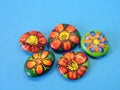 Stones with painted flowers Royalty Free Stock Photo