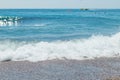 Stones, pebbles beach, blue sea and sky.Pebble beach with azure sea water and small waves with rocks.Water washing on Royalty Free Stock Photo