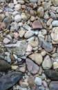 Stones and pebbles near to little stream from waterfall