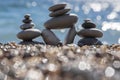 Stones and pebbles stack, harmony and balance, three stone cairns on seacoast with ocean waves on background Royalty Free Stock Photo
