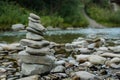 Stones pyramid. Balancing Zen stones on the river bank. Stone Stacked on green nature background. Rock cairn Royalty Free Stock Photo