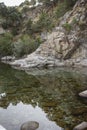 Stones and reflection in the water in the Alardos gorge in Madrigal de la Vera, Caceres, Extremadura, Spain, Europe.