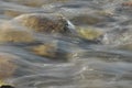 Stones in the river. Fast flowing water. Refreshing mountain river stream. The stream of crystal water. Royalty Free Stock Photo