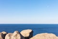 Stones, rocks, blue ocean water and sky horizon background Royalty Free Stock Photo