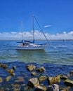 Stones and sailboat at the beach in WarnemÃÂ¼nde. Mecklenburg-Vorpommern, Germany Royalty Free Stock Photo