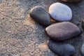 Stones on the sand on the beach in the rays of dawn