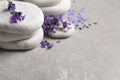 Stones, sea salt and lavender flowers on table, closeup. Space for text Royalty Free Stock Photo