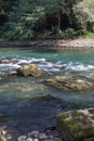 Stones in shallow water in a mountain river