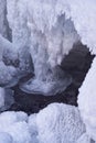 Stones with snow caps and ice in the water of frozen river in winter