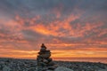 Stones stack on sea rocky beach with sea and sunset sky background Royalty Free Stock Photo