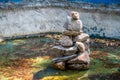 stones stacked in a pyramid in an abandoned pond, against the backdrop of water and fallen leaves Royalty Free Stock Photo