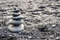 Stones stacked on top of a black beach in Iceland with copy space. Royalty Free Stock Photo