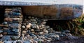 Stones Supporting An Old Boat Hull On Land Royalty Free Stock Photo