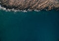 Stones, turquoise waves and sea foam from above. Atlantic ocean coastline with rocks. Aerial drone photography Royalty Free Stock Photo