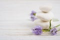 Stones and twigs with lavender flowers on wooden table